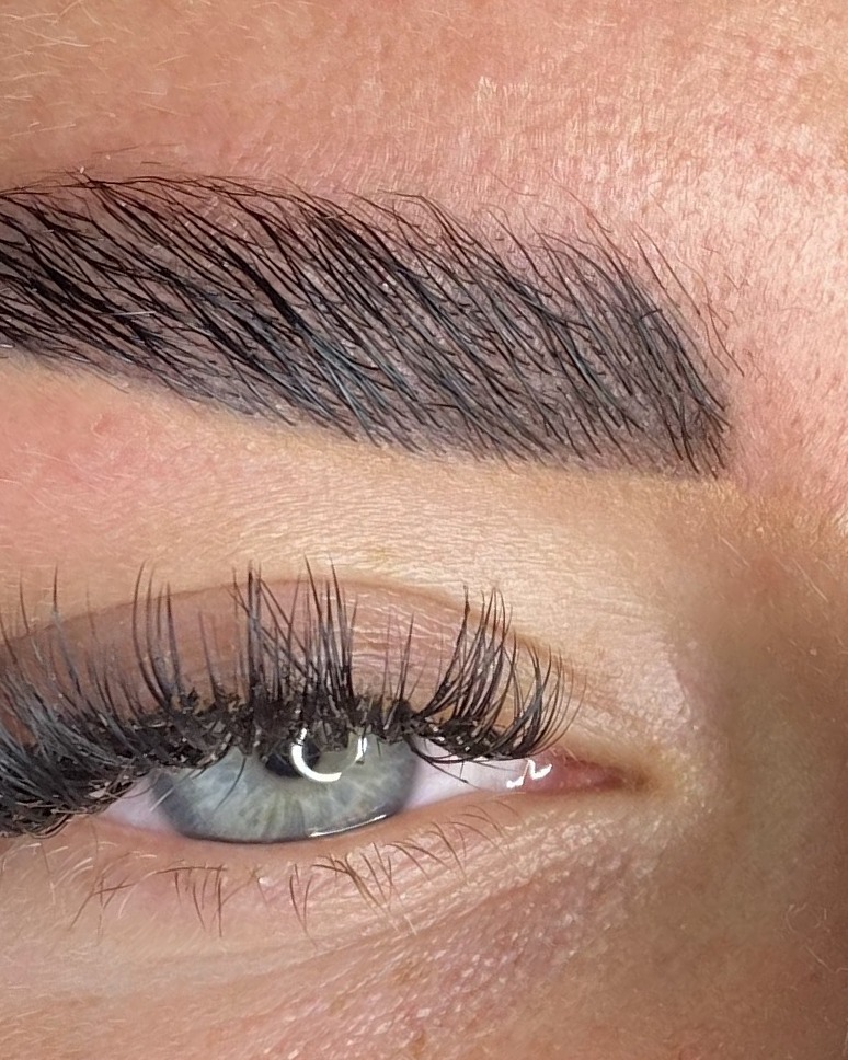 Close-up van een gelamineerde wenkbrauw boven een oog met wimperextensions